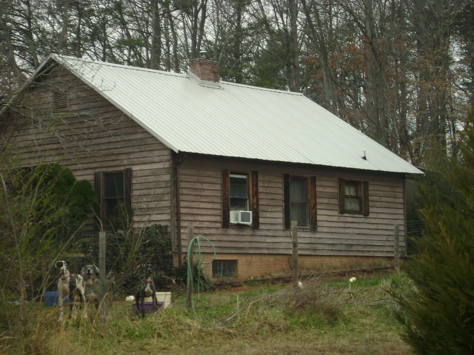 White metal roof on an old wood sided farmhouse, from a Asphalt Shingle Roof Repair job in Jewell